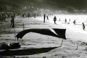 the crowded beach, the tent and the waves